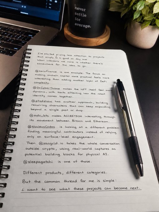 A handwritten journal entry on a notebook page next to a laptop and pen, discussing crypto/Web3 projects including @zerofinance, @oraborus (r/CyberThrone), @pidsshow, @mdv_btc (ACCRETION), @NucleusCodes, @vangrld_io, and @sleepagotchi, with the concluding thought that the writer wants to see what these projects can become next.
