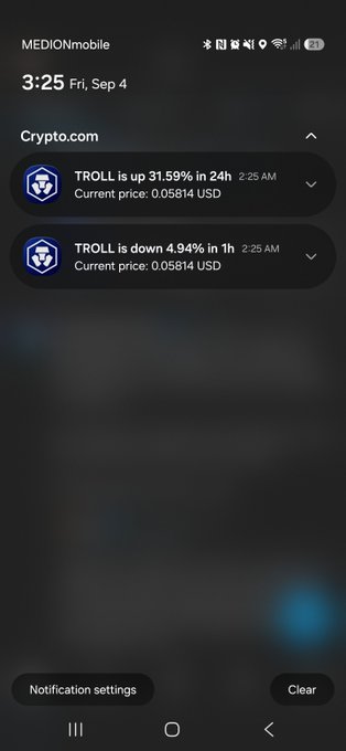A smartphone screenshot showing Crypto.com price alerts for the $TROLL token at 3:25 AM, displaying it's up 31.59% in 24 hours while simultaneously down 4.94% in the last hour—both notifications timestamped at 2:25 AM with a current price of 0.05814 USD, humorously confirming the "am I being trolled" caption.