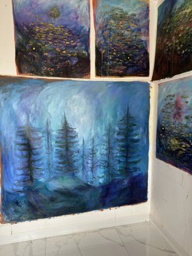 A corner gallery display of impressionist-style oil paintings featuring moody blue, purple, and dark tones with subjects including evergreen trees and floral landscapes.