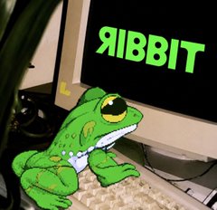 A green cartoon frog sits at a computer keyboard with the word 'RIBBIT' displayed in glowing green letters on the monitor screen.