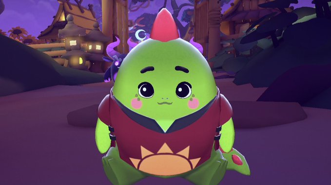 The image features a green, anthropomorphized character with a red comb and a pink shirt sitting down. The character has a big smile on its face, giving off a friendly vibe. The background of the image shows a forest or woods area, which adds to the overall atmosphere of the scene. The post about sleepagotchi seems to be related to this image as it talks about how @sleepagotchi encourages people to prioritize their sleep and maintain healthy habits by rewarding them with virtual items for completing their sleep goals.