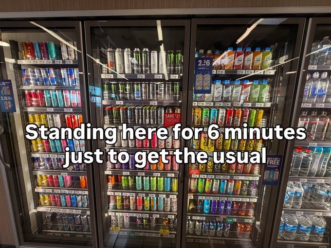 A convenience store refrigerated cooler stocked with various drinks, overlaid with text reading: 'Standing here for 6 minutes just to get the usual'.