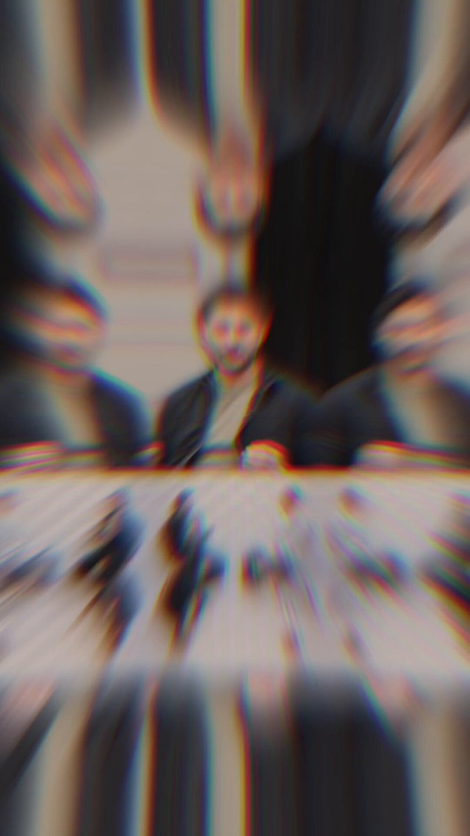 The image shows a group of people sitting around a table at a conference or event. The focus of the photo is on one person who appears blurry due to the camera's autofocus system, which is capturing their face as part of the picture. This highlights the importance of live events and human interaction in today's world, where AI-driven technologies are increasingly shaping our experiences. The image also mentions Bitcoin Inc., which could be related to the conference or event taking place, emphasizing the relevance of such gatherings in the digital age.