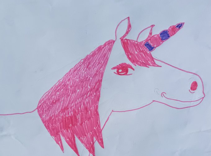 A child's hand-drawn illustration of a pink unicorn with a purple-tipped horn, created with pink marker on white paper. The artwork aligns with the "Pink stardust" title from the post, likely serving as the token's featured image on the Tezos-based objkt.com marketplace.