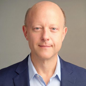 The image is a headshot of Jeremy Allaire, the CEO of Circle, wearing a blue blazer and light blue shirt against a gray background. He is referenced in the caption as having spoken to Bloomberg about the failed CLARITY Act cloture vote, noting that the GENIUS Act initially faced setbacks but ultimately succeeded.