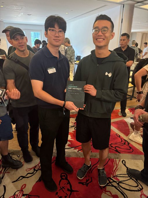 Two men pose together holding a book titled "The Fixed-Income Half-Year Report," with one wearing a "Four Pillars" name tag and the other in a dark hoodie, while the surrounding post from Four Pillars highlights a meaningful encounter at a conference where their CSO met Chameleon Jeff, who recognized their research work.