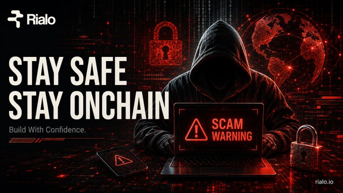 A promotional banner for Rialo with the text 'STAY SAFE STAY ONCHAIN Build With Confidence,' depicting a hooded figure at a laptop showing a 'SCAM WARNING' alert, with a padlock and globe imagery.