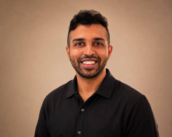 A man with short curly dark hair and a beard smiles warmly at the camera while wearing a black button-up shirt against a warm beige backdrop, appearing in a professional headshot that accompanies his announcement of stepping into a new role as Principal at Hashgraph Ventures.

There is no visible text in the image.