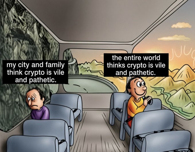 A meme shows a man in a car looking out at a bright landscape while thinking, 'the entire world thinks crypto is vile and pathetic,' while a sad character behind him represents the belief that 'my city and family think crypto is vile and pathetic.'