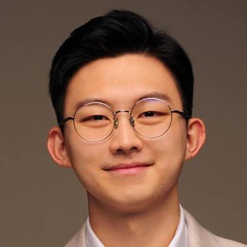 A young man wearing round wire-frame glasses and a light-colored blazer poses for a portrait against a neutral gray background, matching the appearance of Ki Young Ju, founder of CryptoQuant, whose quote questioning whether Bitcoin has reached its cycle bottom accompanies the image.