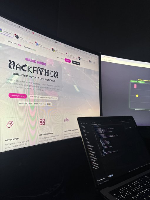 A dual-monitor workstation displaying the 'Backpacken' Game Mode Library website on the left monitor and 'Candle Dodger' on the right, with a laptop running code in the foreground.