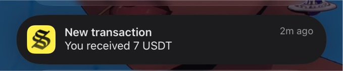 A notification banner with a yellow logo reading 'New transaction - You recieved 7 USDT' timestamped '2m ago'.