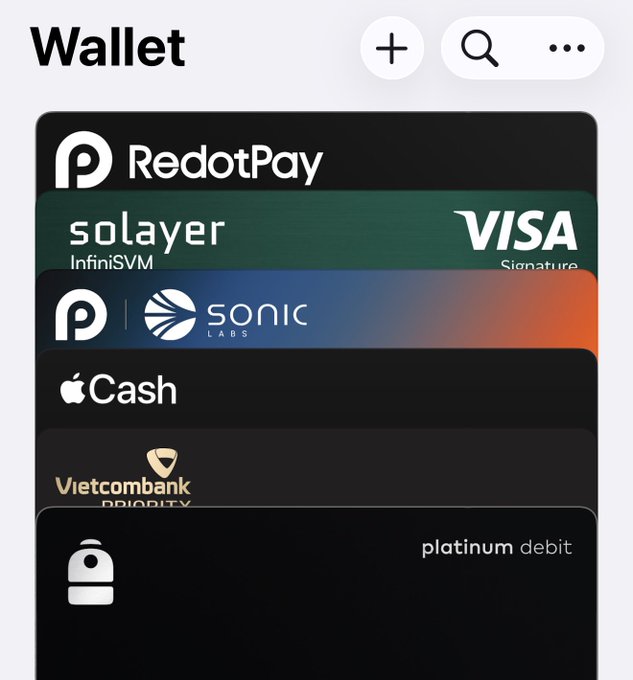 A mobile wallet interface displaying stacked cards including 'RedotPay', 'solayer InfiniSVM VISA Signature', 'sonic LABS', 'Apple Cash', 'Vietcombank PRIORITY', and a 'platinum debit' card.