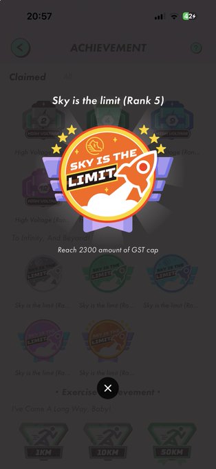 A mobile app screen showing an 'ACHIEVEMENT' for 'Sky is the limit (Rank 5)' with a rocket badge, instructing to 'Reach 2300 amount of GST cap' as part of an exercise achievement system.