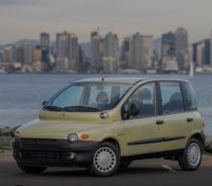 A compact yellow Daewoo hatchback is parked in front of a city skyline, likely serving as a visual punchline to the joke about "NPC bottom sellers" settling for a modest economy car instead of an aspirational Lamborghini. The image contrasts the mundane reality of an affordable commuter vehicle with the lofty dreams implied by the meme's text.