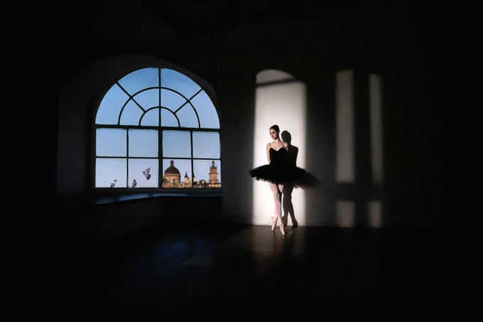 A ballerina in a black tutu stands poised in a dimly lit room beside an arched window, silhouetted against the soft daylight illuminating a distant domed cityscape.

The accompanying post references a 1/1 NFT artwork titled "GE" on Transient, with the "Wait For Me" caption and 0.3 ETH price tag evoking themes of longing and separation that visually parallel the lone dancer's solitary pose in an empty hall.