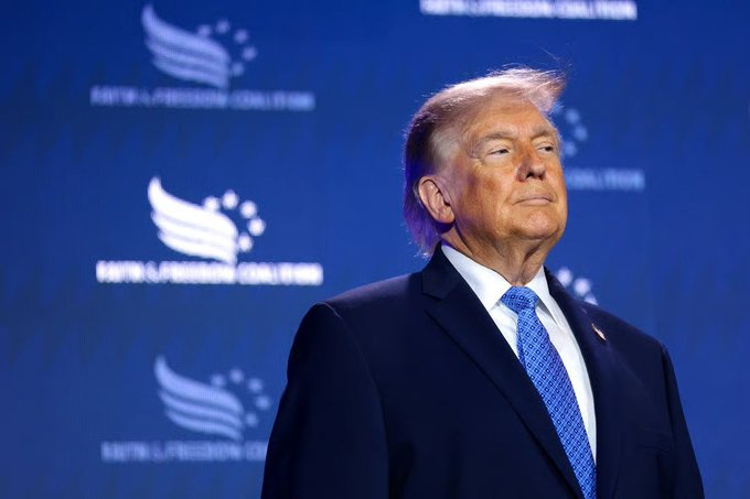 Donald Trump stands before a backdrop featuring the "FAITH & FREEDOM COALITION" logo, as the accompanying post claims he made over $2.2 billion in his first year back in the White House.