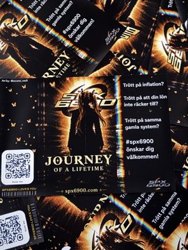 A pile of promotional flyers or cards for "Journey of a Lifetime," an SPX6900-themed event or promotion, featuring dark imagery and text in multiple languages including Swedish and Finnish.