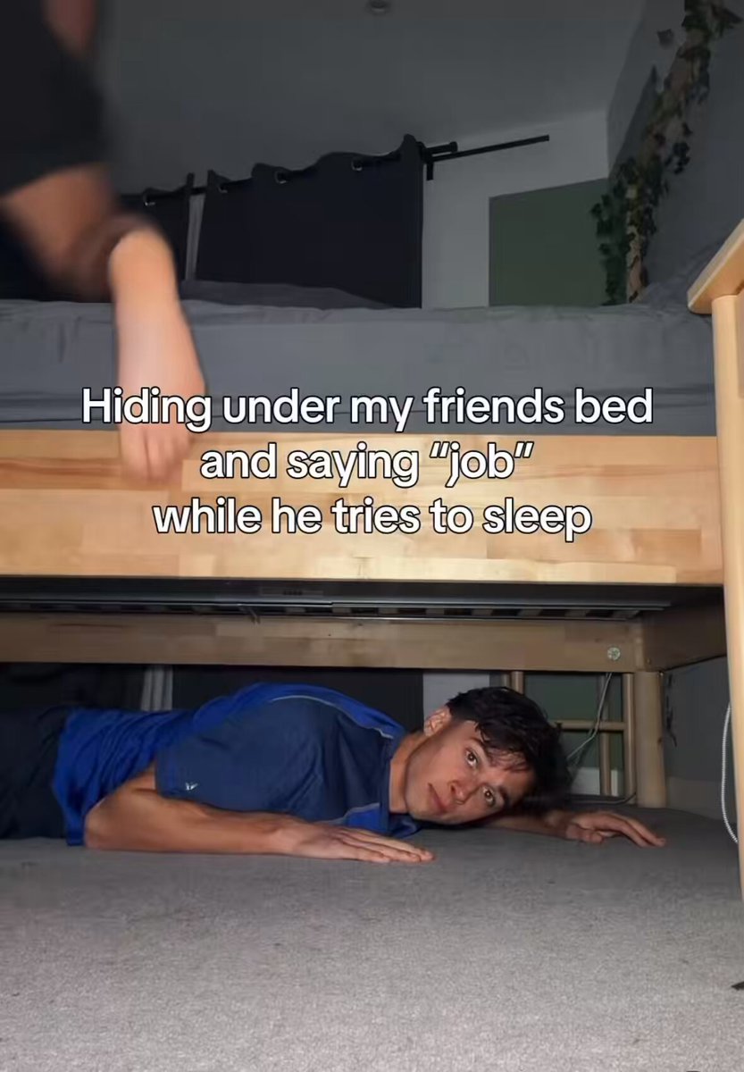 The image shows a person lying down on their stomach, with their head resting on a bed frame or wooden slats. They are wearing a blue shirt and appear to be in a relaxed position. The caption of the image reads "$neet", which is likely a reference to the popular social media account @theshowsheets.