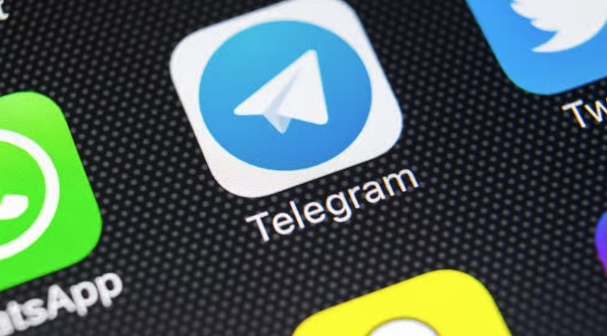 A close-up shot of app icons on a smartphone screen, prominently displaying the Telegram logo alongside WhatsApp and Twitter icons. The image visually ties to the announcement about Telegram CEO Pavel Durov's plans to launch a non-custodial crypto wallet for the platform's billion users.