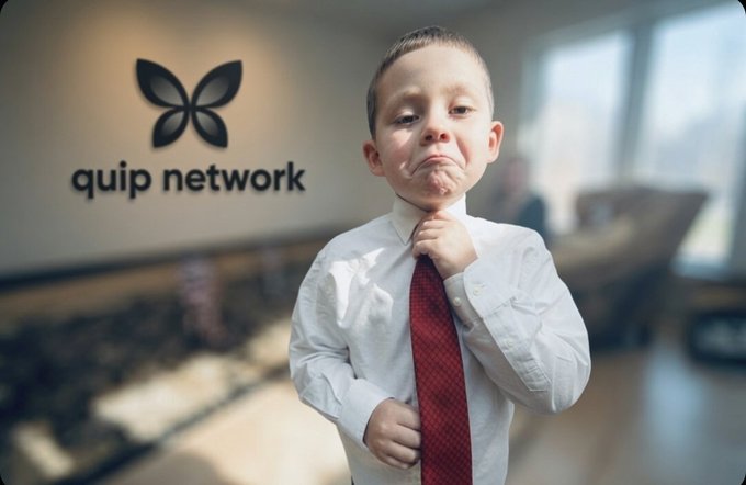 The image features a young boy wearing a white shirt, red tie, and making a funny face as he adjusts his tie with his mouth open. The background of the image shows a window, suggesting that they are indoors or possibly in an office setting. There is also a logo for Quip Network visible on the wall behind the boy.