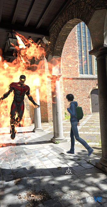 The image features a man dressed as a superhero, with flames coming out of his mouth, flying through the air next to a woman who appears to be walking away from him. The scene takes place outdoors, possibly near an archway or doorway. The caption provided seems unrelated and does not provide any context about the image's content.