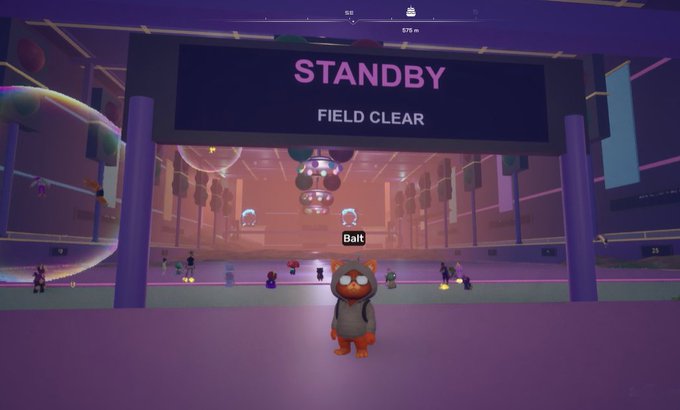 A screenshot from a video game showing a character named 'Bait' wearing a raccoon mask standing in front of a 'STANDBY FIELD CLEAR' display sign.