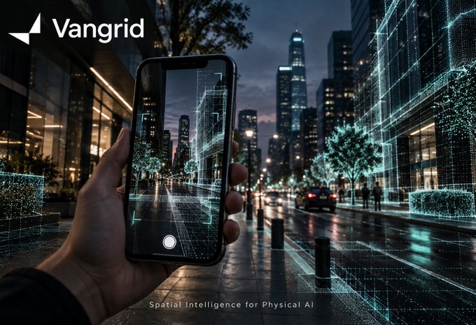 A promotional image for 'Vangrid' showing a hand holding a smartphone that displays an augmented reality view of a city street, with the tagline 'Spatial Intelligence for Physical AI'.