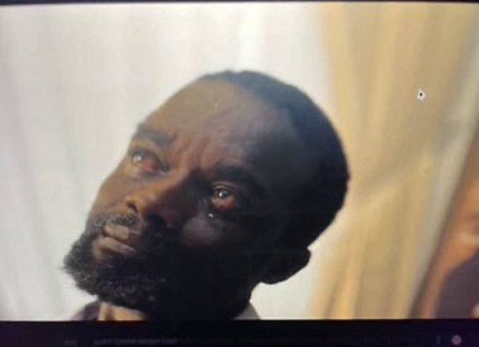 The image shows a close-up of a man with a beard, looking upward with a contemplative or sorrowful expression, seemingly in a dramatic scene. This emotionally charged visual likely accompanies the post's plea for community support and vouchers, evoking sympathy to boost shares and engagement for the cause.