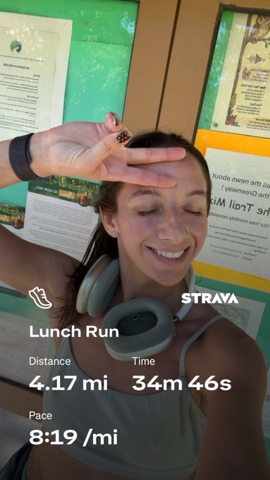 A Strava "Lunch Run" activity screenshot showing Distance: 4.17 mi, Time: 34m 46s, and Pace: 8:19/mi, overlaid on a selfie of a smiling woman with headphones around her neck.