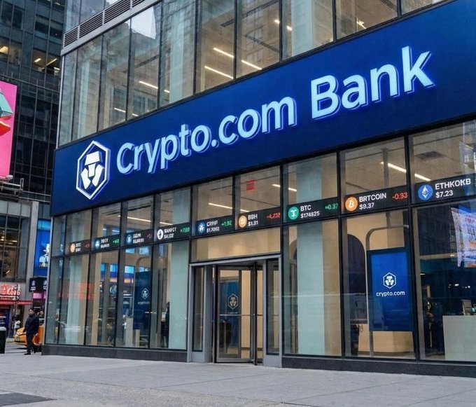 This image shows the Crypto.com Bank building with cryptocurrency tickers displayed. It relates to rumors about CRO ETFs, as seen from the Crypto.com branding and associated tickers.