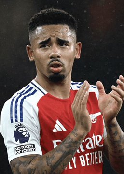 A close-up photo of Arsenal soccer player Gabriel in a red and white jersey featuring the 'Visit Rwanda' and 'No Room For Racism' patches.