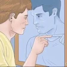 A cartoon-style illustration depicts a young person pointing at their reflection in a mirror, suggesting themes of self-identity or introspection.