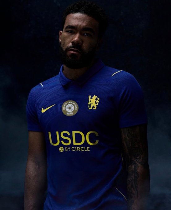 A soccer player wearing a blue Chelsea FC jersey with USDC by Circle sponsor logo and FIFA Club World Cup Champions badge.