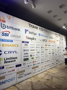 A sponsor wall at WebX displays a wide array of crypto and fintech company logos, including Binance, SBI Group, bitbank, BitFlyer, KuCoin, Indodax, ADVASA, and others, illustrating the post's observation that web3-related talk themes have been largely replaced by more traditional financial and fintech players.