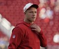 A man in a red hoodie and white cap stands with his hand on his chest, appearing to reflect with a mixed expression of emotion and contemplation. The image pairs with the caption "Just accidentally thought about 2024 CMC," suggesting a nostalgic or bittersweet moment of remembering past experiences.