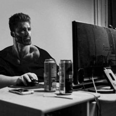 A black-and-white photo shows a man sitting at a desk with a computer monitor and two energy drink cans beside him, appearing engaged in conversation online. The accompanying post humorously captures a crypto Twitter exchange about the Clarity Act, where two people argue its market impact—bearish or not—without either having actually read the legislation.