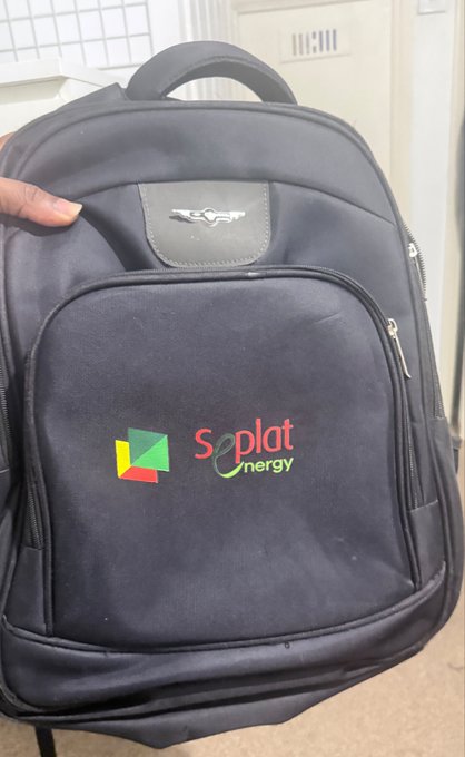 A black backpack branded with "Seplat Energy" logo, featuring a colorful leaf emblem, being held up against a light-colored background.