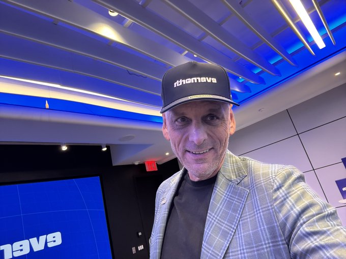 A man wearing a "rthemave" cap and a checkered blazer smiles in what appears to be a Nasdaq studio, with the Nasdaq logo visible on a screen in the background, connecting to the tagged accounts @evernorthxrp, @Arrington_Cap, and @Nasdaq.
