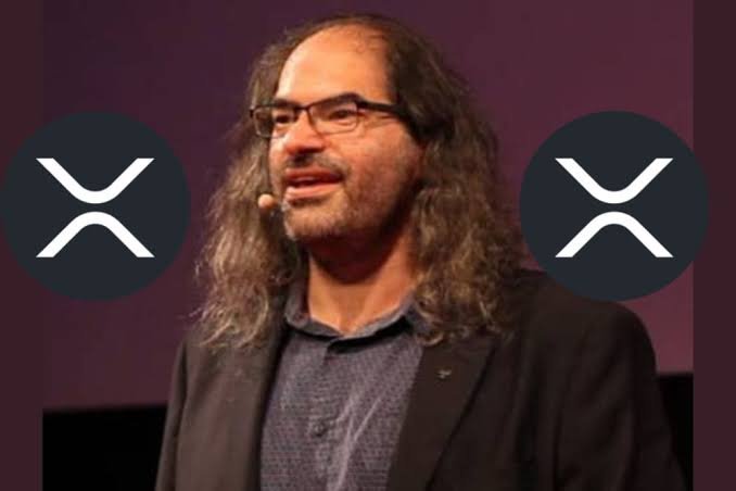 David Schwartz, Ripple's Chief Technology Officer, appears in the image flanked by two XRP logos, visually reinforcing his stated belief—shared in a post on X—that XRP could eventually become the world's reserve currency.