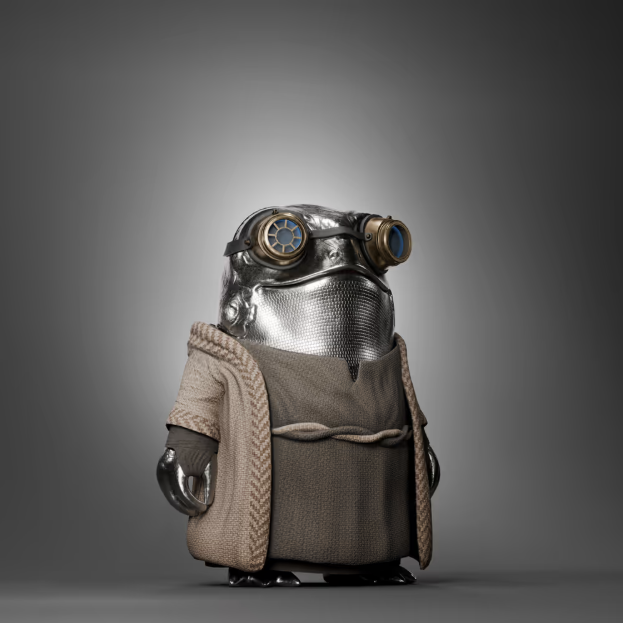 A small, stylized robot figure wearing a textured metallic mask with blue goggles and a brown, knitted sweater-like garment.