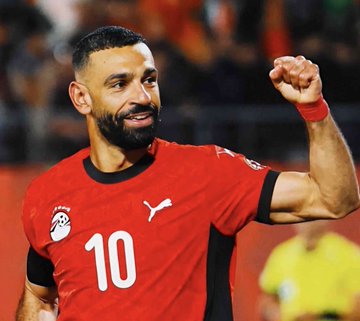 Mohamed Salah in his Egypt #10 jersey celebrates on the pitch, an image relevant to the Argentina vs Egypt match referenced in the Polymarket betting news.