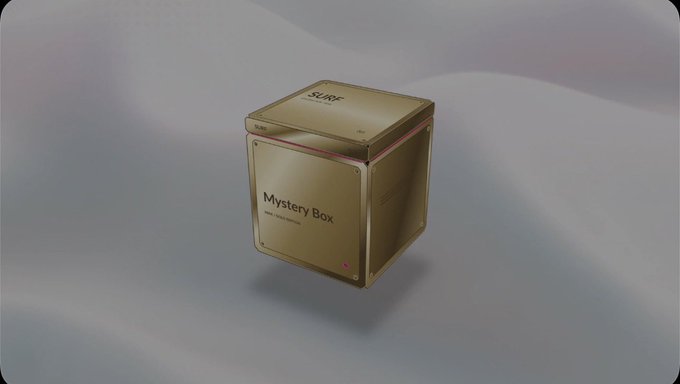 A gold 3D-rendered "Mystery Box" floating against a soft, flowing background, with "SURF" visible on top and "Mystery Box" labeled on the side panel.