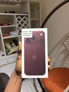 A hand holds up a red iPhone 13 in its original Apple packaging, with a label reading "IPHONE 13 PRO 128GB GBA" visible at the top. The image illustrates the post's comparison between buying an expensive new iPhone (which quickly depreciates) versus investing $1,800 in three Argonauts, which have tripled in value within a month.
