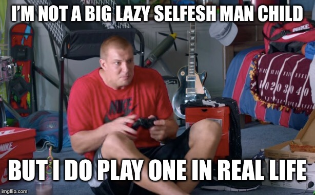 The meme shows a man in a cluttered bedroom sitting on the floor playing video games, wearing a Nike shirt, surrounded by soda boxes, with the caption "I'M NOT A BIG LAZY SELFISH MAN CHILD BUT I DO PLAY ONE IN REAL LIFE." The image humorously illustrates the post's point about someone who never grew up, using the self-aware punchline to mock a person whose personality has stayed childish despite adulthood—just like a grown man playing video games surrounded by clutter.