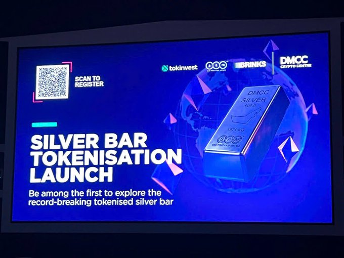 A presentation slide titled 'SILVER BAR TOKENISATION LAUNCH' displays a 3D rendered silver bar against a blue globe background, featuring a QR code 'SCAN TO REGISTER', and logos for tokinvest, ABCM, BRINKS, and 'DMCC CRYPTO CENTRE'.
