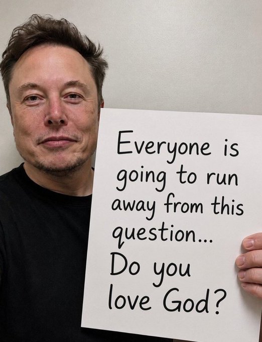 Elon Musk holds up a white sign that reads 'Everyone is going to run away from this question... Do you love God?'