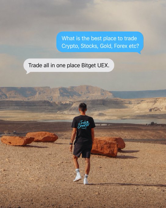 A person in a black t-shirt and shorts standing on a desert landscape overlooking a canyon, with overlaid text bubbles asking 'What is the best place to trade Crypto, Stocks, Gold, Forex etc?' and answering 'Trade all in one place Bitget UEX.'