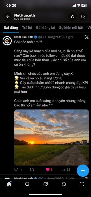 A Twitter/X post in Vietnamese from user NetHue.eth (@GiaHung2609) sharing a good morning message about having abundant energy and enthusiasm to conquer KPIs, accompanied by a sunset photo over a rural path.