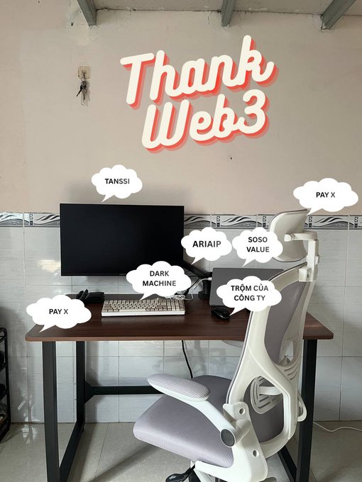 A desk setup with a monitor and ergonomic chair, featuring a neon 'Thank Web3' sign on the wall and speech bubble stickers with text including 'TANSSI!', 'ARIAIP', 'SOSO VALUE', 'DARK MACHINE', 'TROM CỦA CÔNG TY', and 'PAY X'.